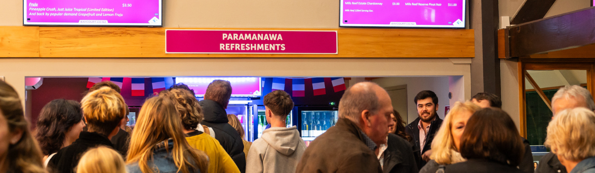 People around the refreshments counter People around the refreshments counter