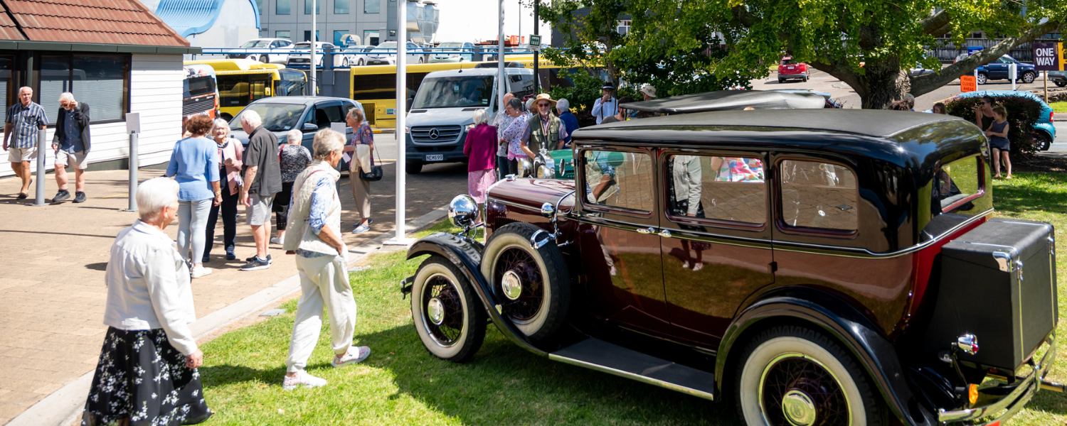 Arrival area outside Baycourt with visitors and vehicles.