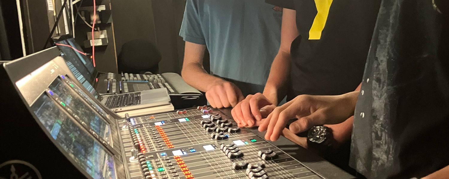 Teen participants learning live event production skills at Baycourt.