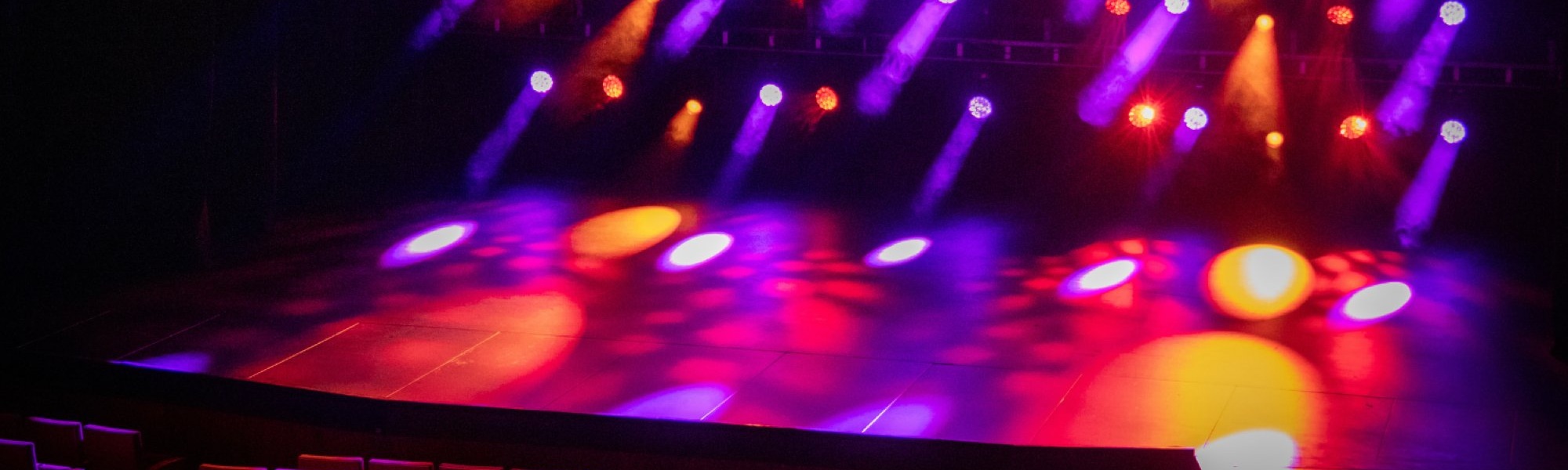 Addison Theatre stage lit in coloured lights ready for performance